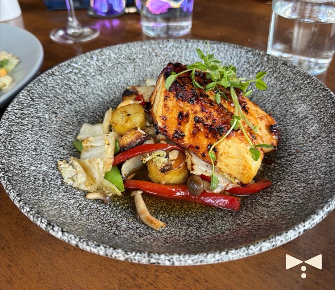 Butler share card showing a miso-glazed sea bass with roasted vegetables, marked with the Butler bow tie